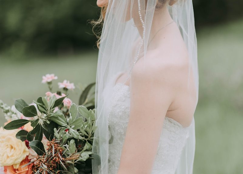 woman wearing white wedding dress with veil