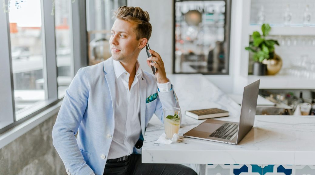 man sitting beside white wooden table